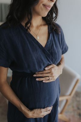a pregnant woman wearing a blue dress