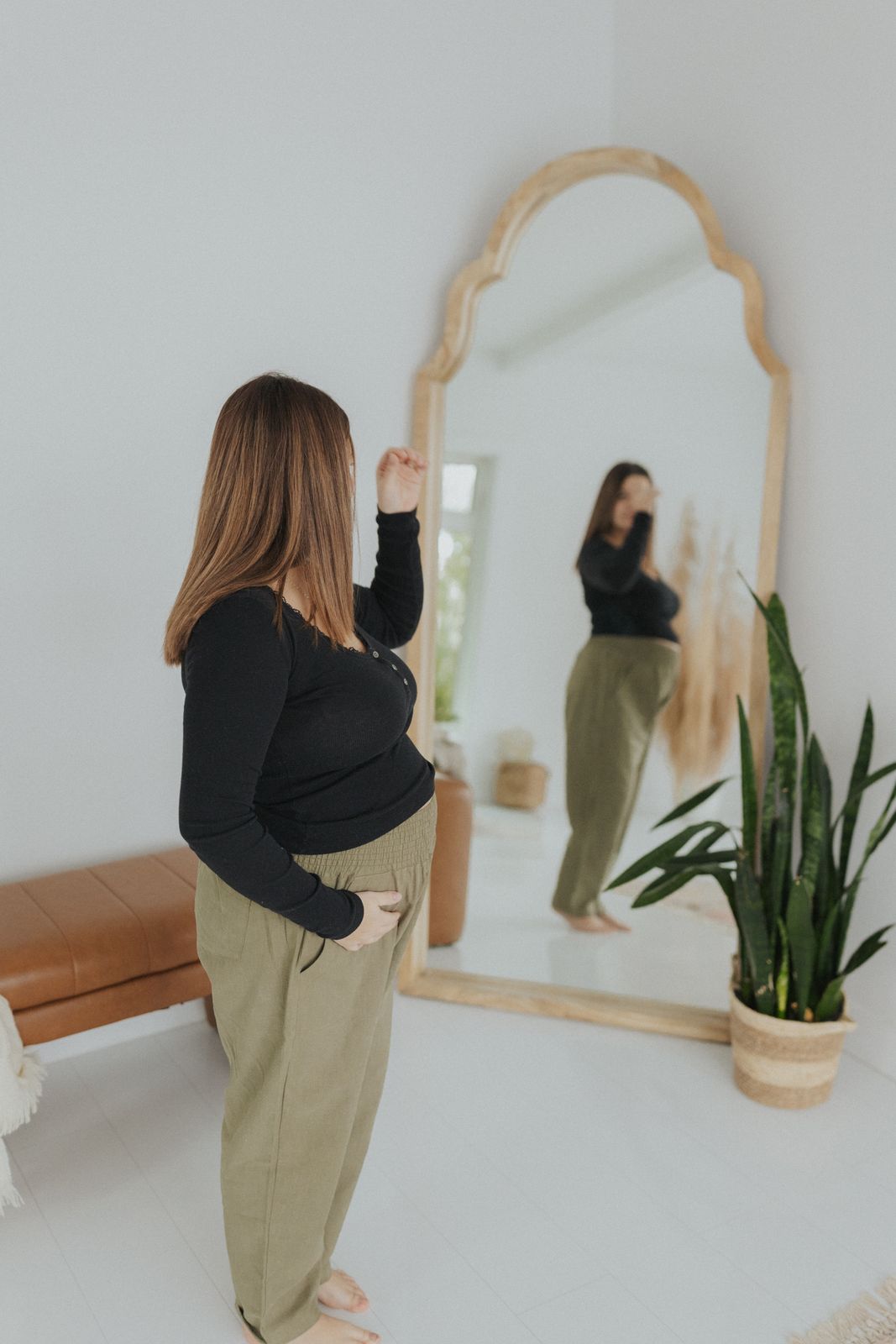 a woman standing in front of a mirror