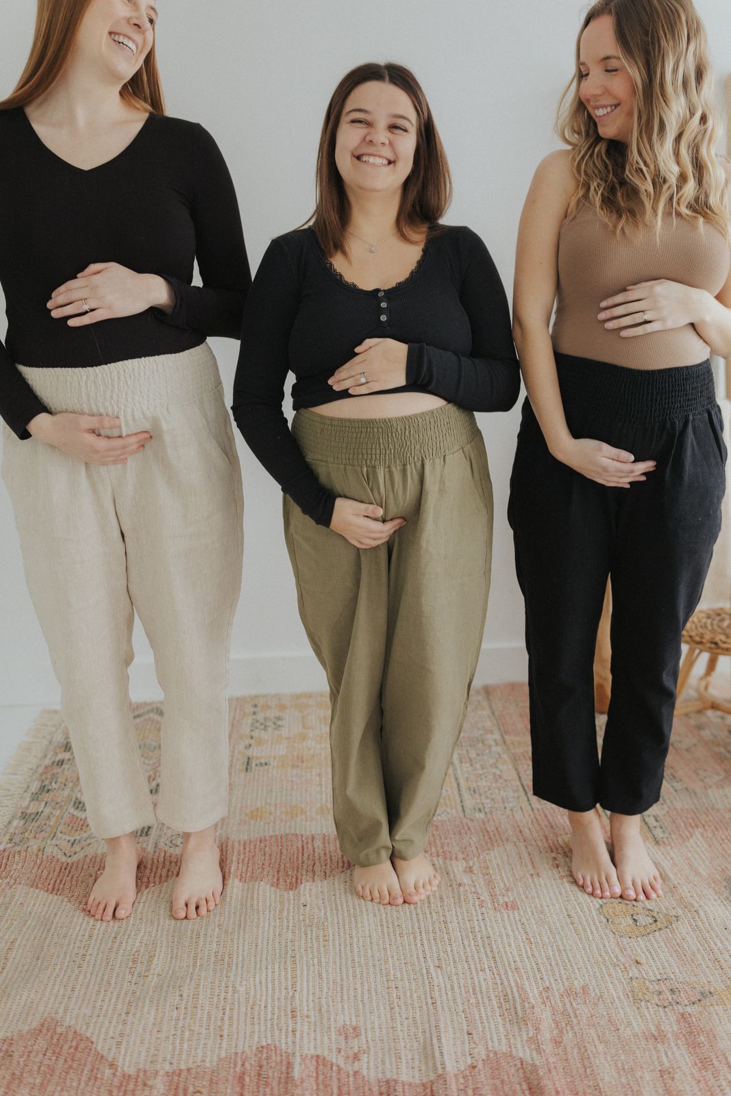 three pregnant women standing next to each other