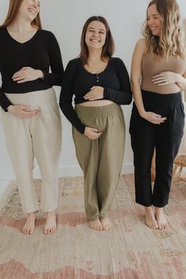 three pregnant women standing next to each other
