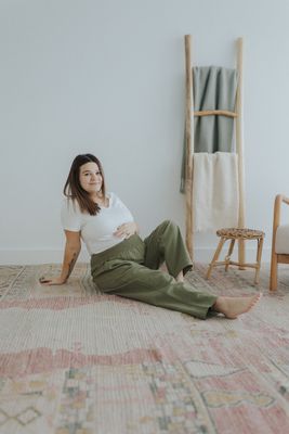 a woman sitting on the floor in a room