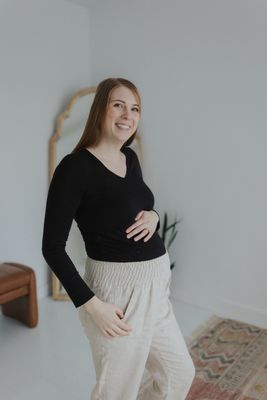 a woman standing in a room with her hands on her hips