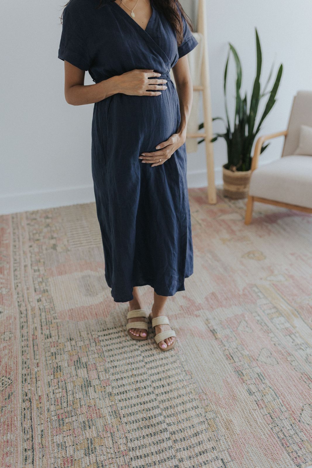 a pregnant woman standing in a living room