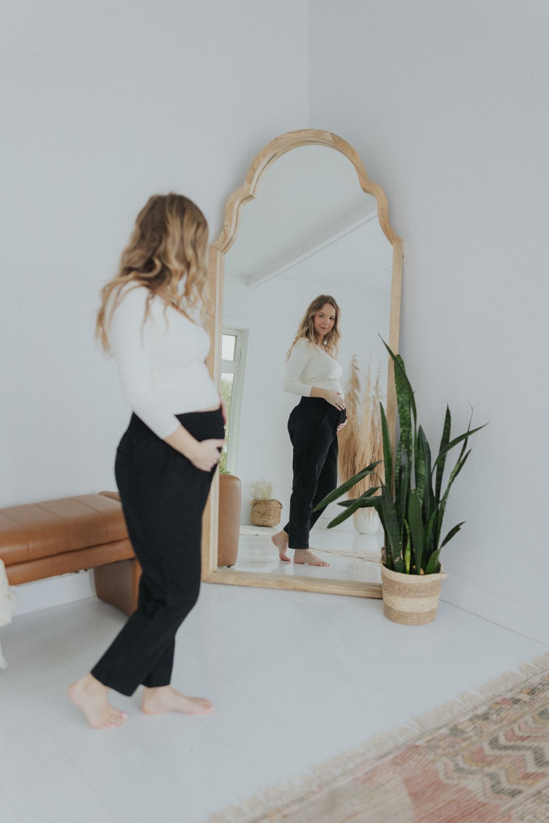 a woman standing in front of a mirror
