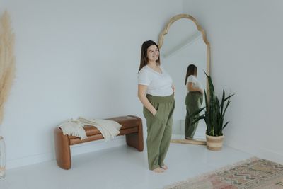 a woman standing in front of a mirror
