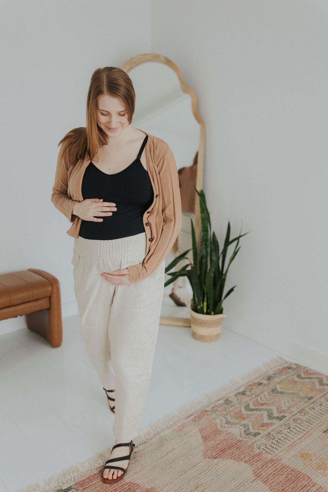 a woman standing in a room with a mirror