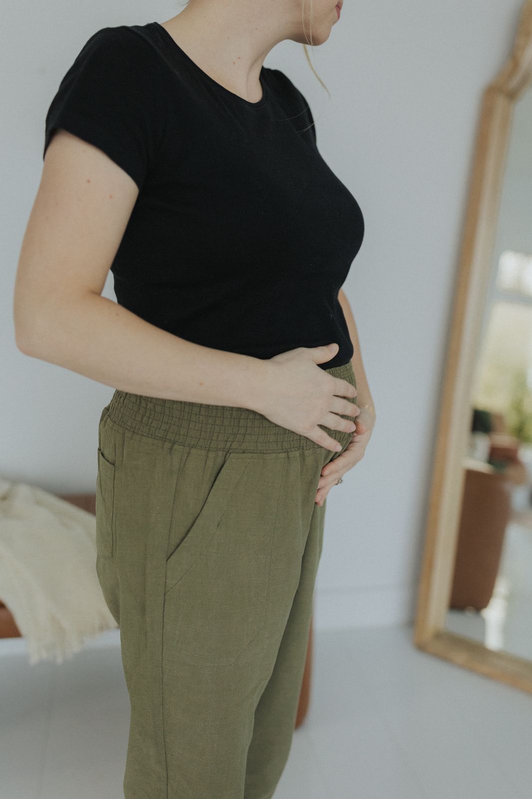 a woman in a black shirt and khaki pants