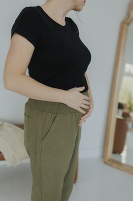 a woman in a black shirt and khaki pants