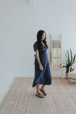 a woman standing on a rug in a room