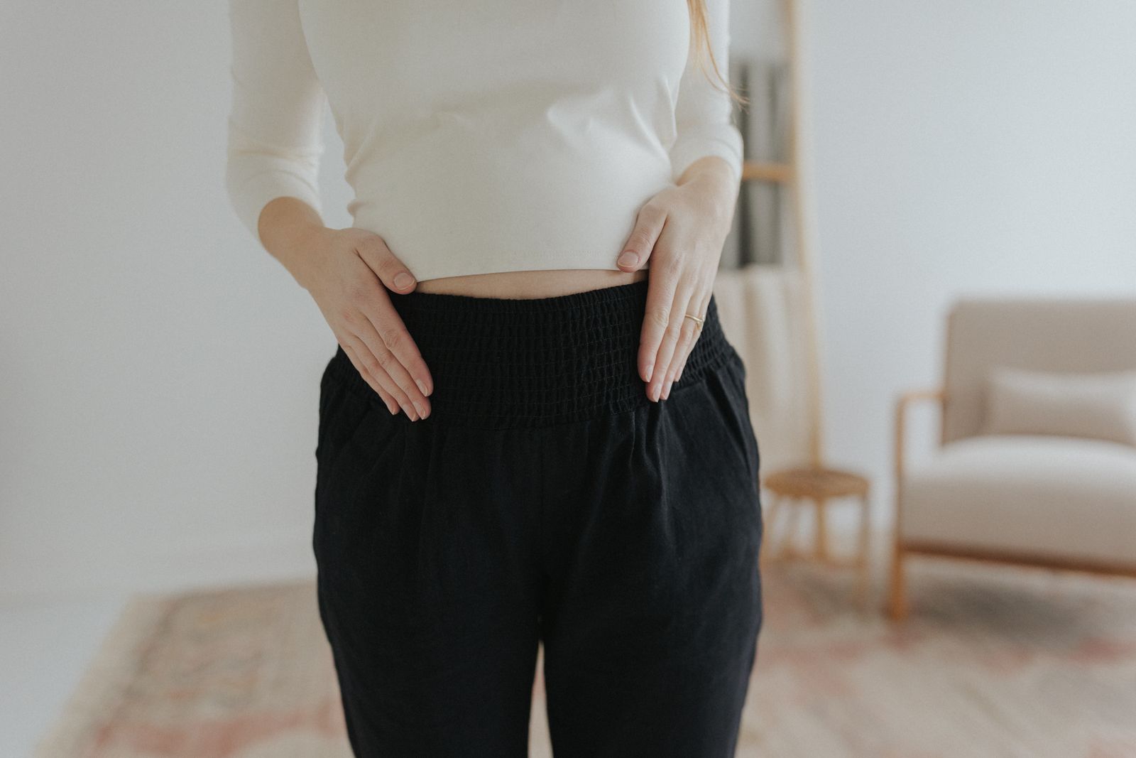 a woman standing in a room with her hands on her hips