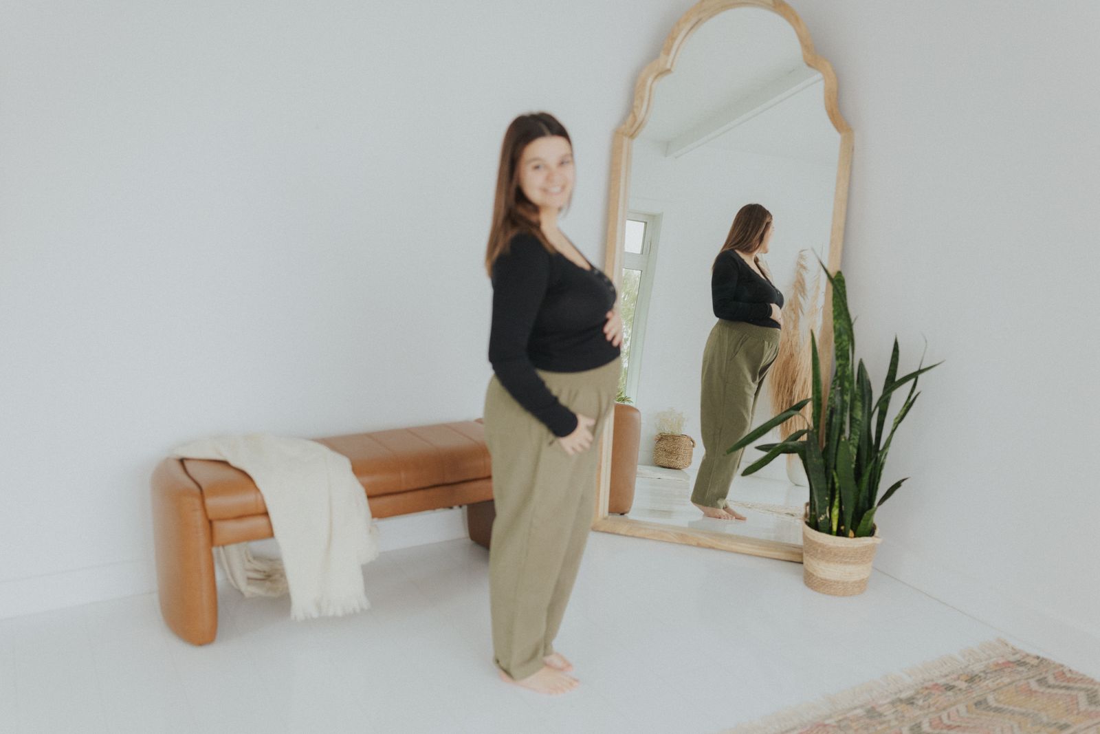 a woman standing in front of a mirror