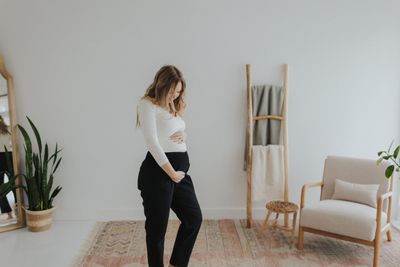 a woman standing on a rug in a room