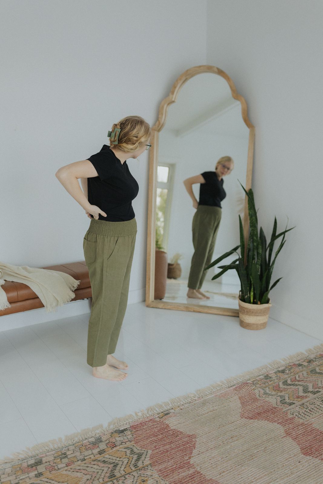 a woman standing in front of a mirror