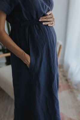 a pregnant woman wearing a blue dress