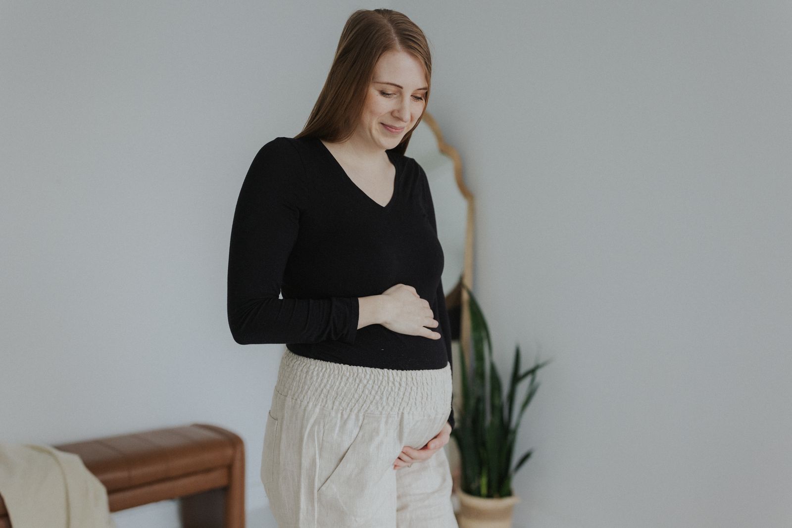 a woman standing in front of a white wall
