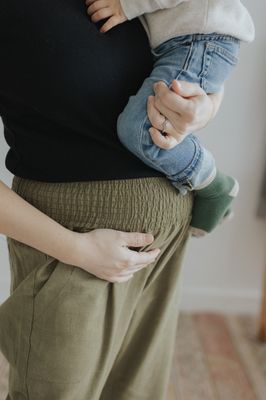 a woman holding a baby in her arms