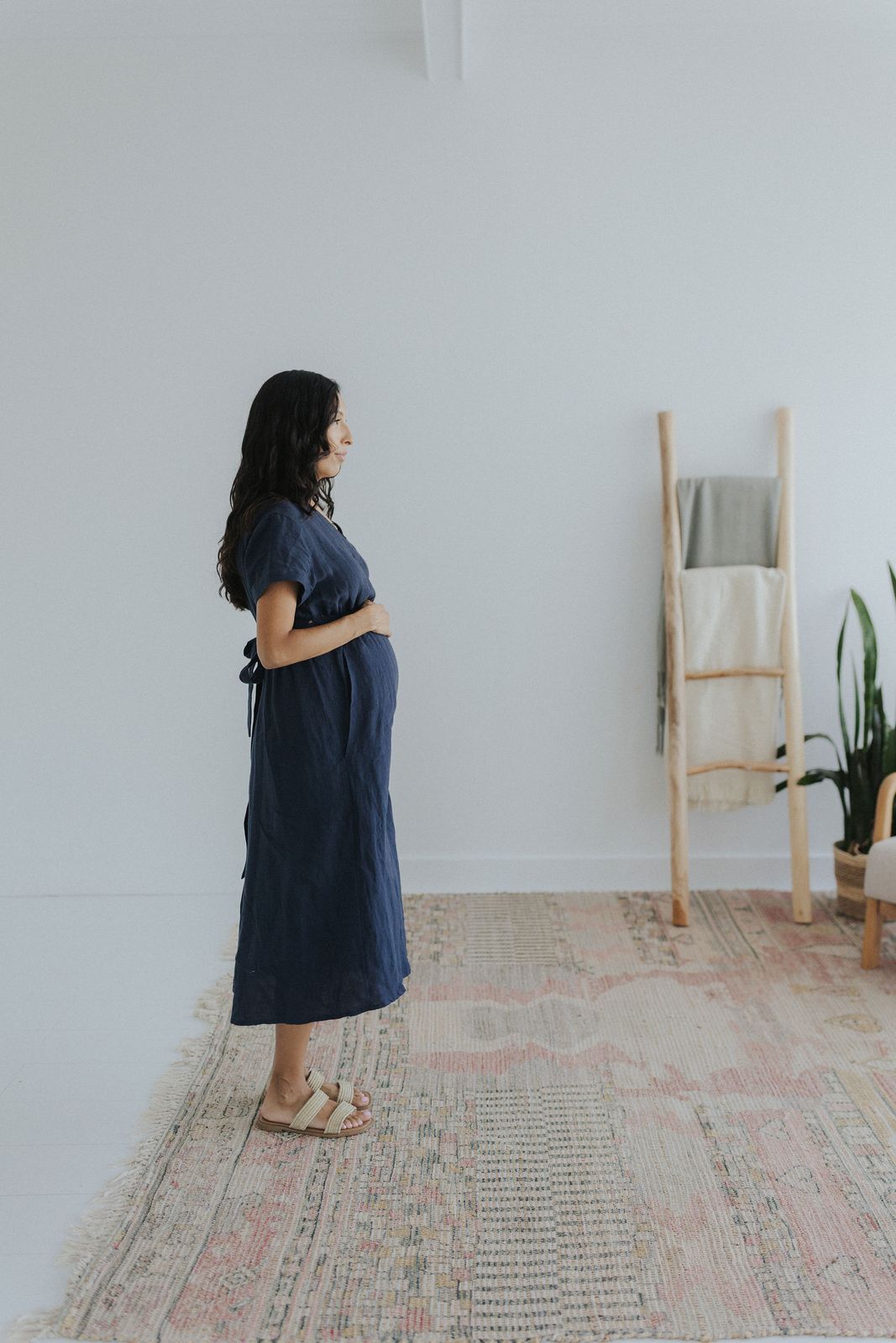 a woman standing on a rug in a room