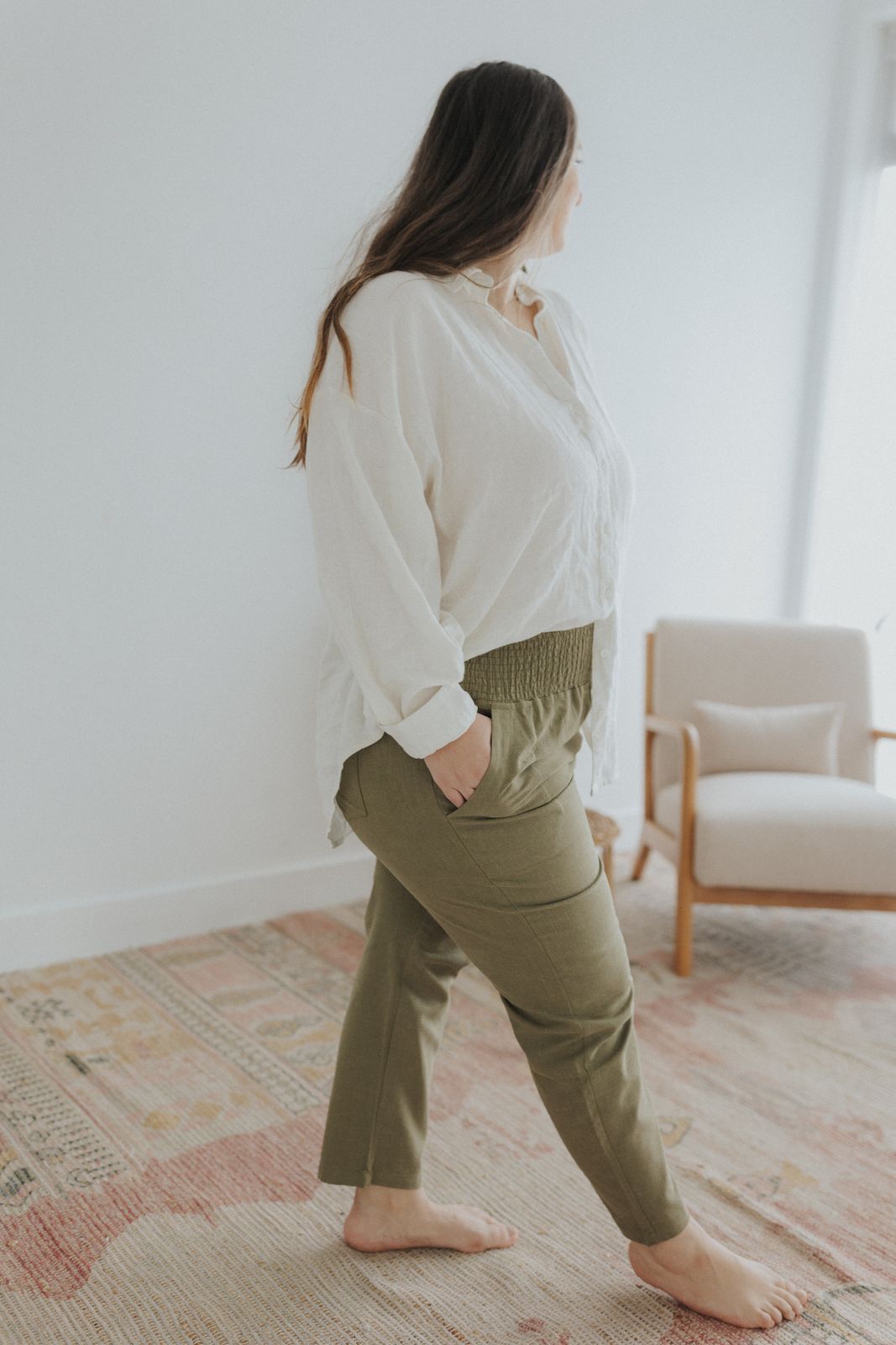 a woman in a white shirt and khaki pants