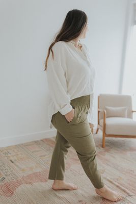 a woman in a white shirt and khaki pants