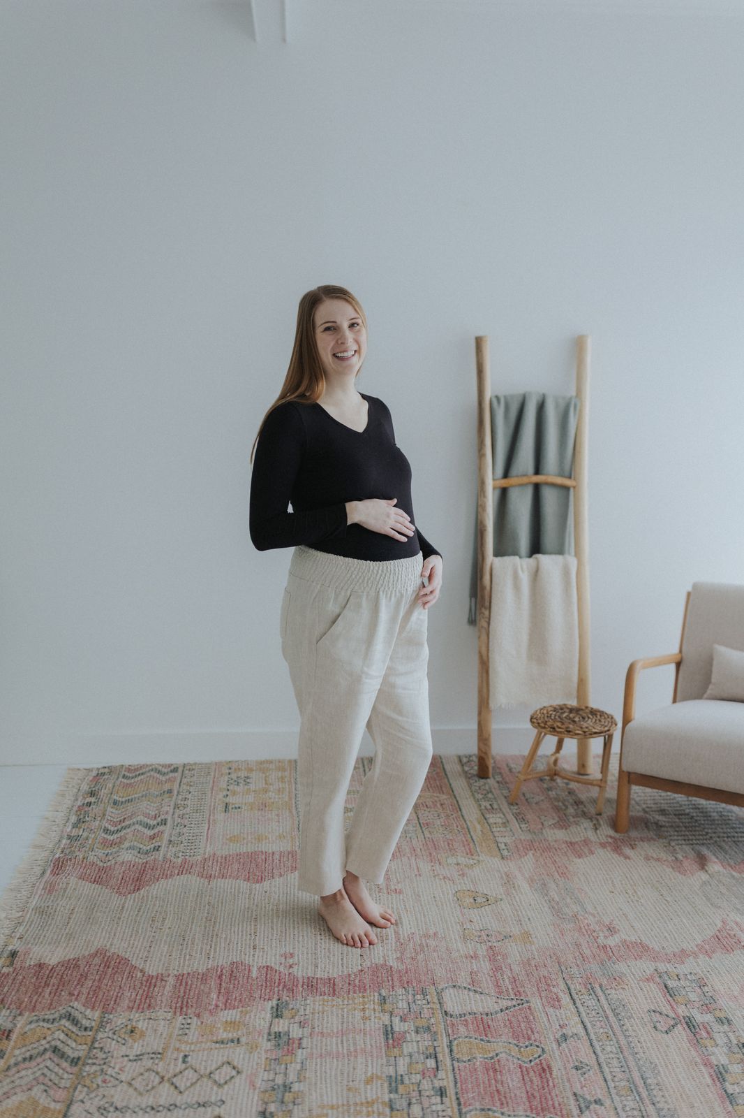 a woman standing in front of a white wall