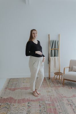 a woman standing in front of a white wall