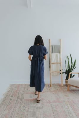 a woman standing on a rug in a room