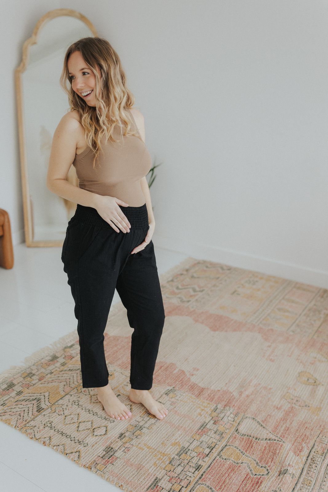 a woman standing on a rug in a room