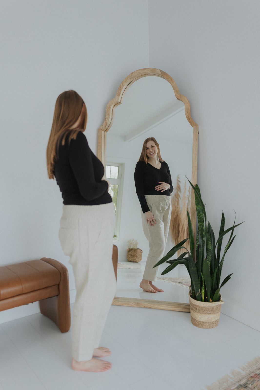 a woman standing in front of a mirror