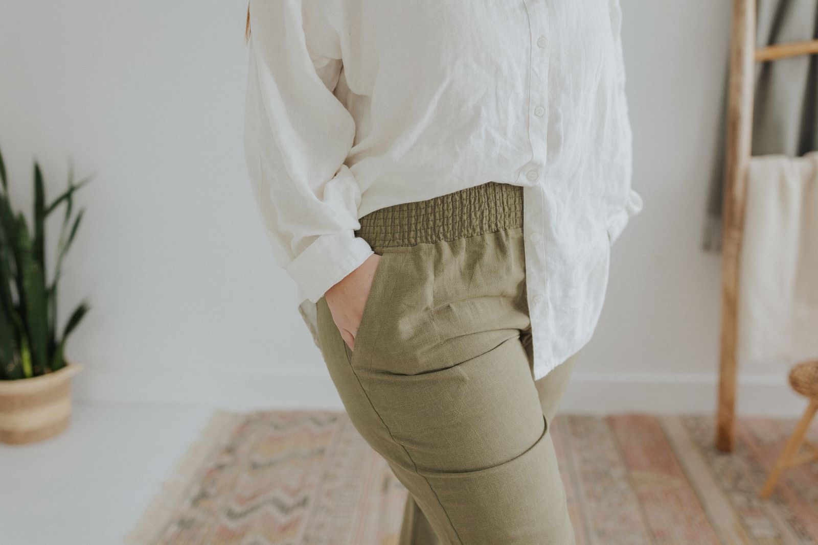 a woman in a white shirt and khaki pants