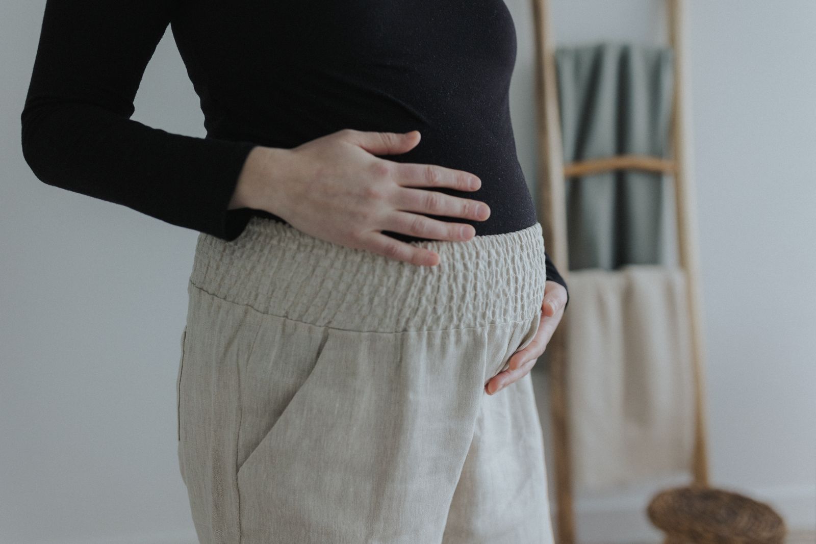 a woman with her hands on her stomach