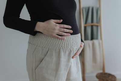 a woman with her hands on her stomach