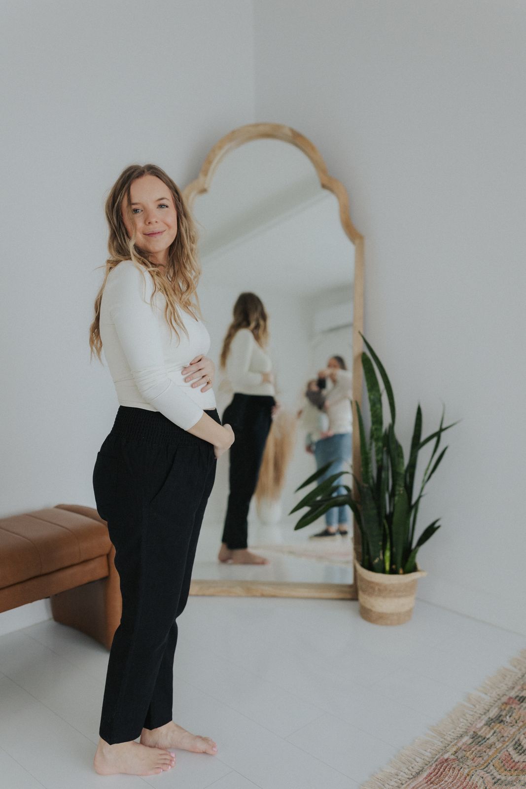 a woman standing in front of a mirror