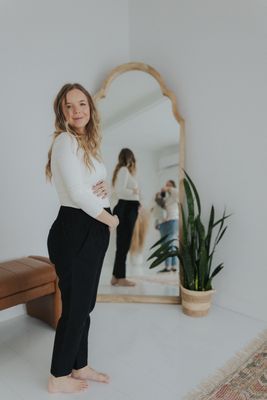a woman standing in front of a mirror