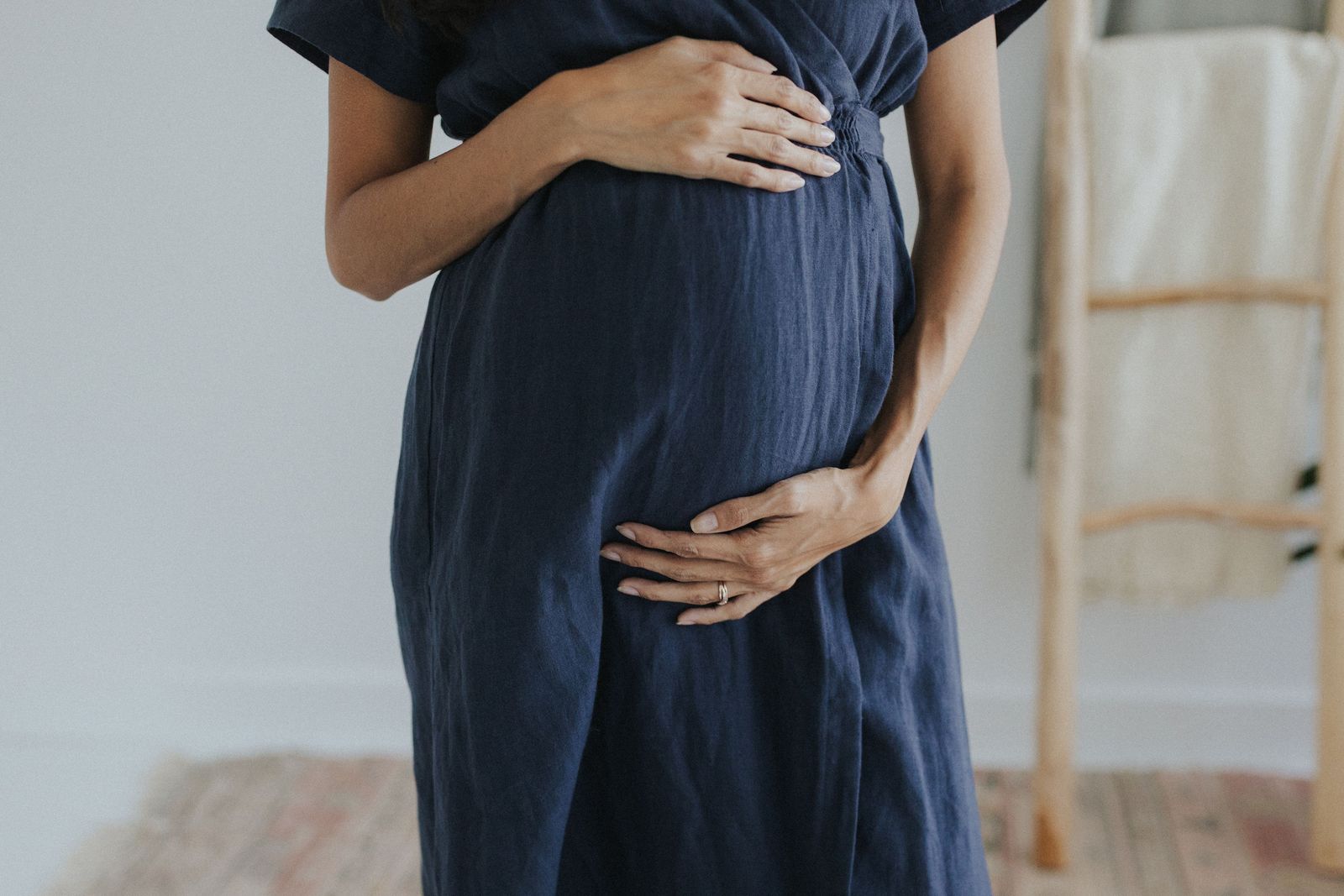 a pregnant woman standing in front of a mirror