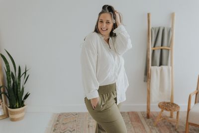 a woman in a white shirt and khaki pants