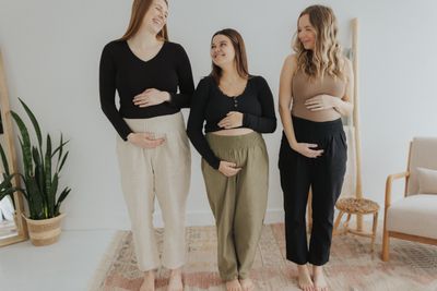 a group of three women standing next to each other