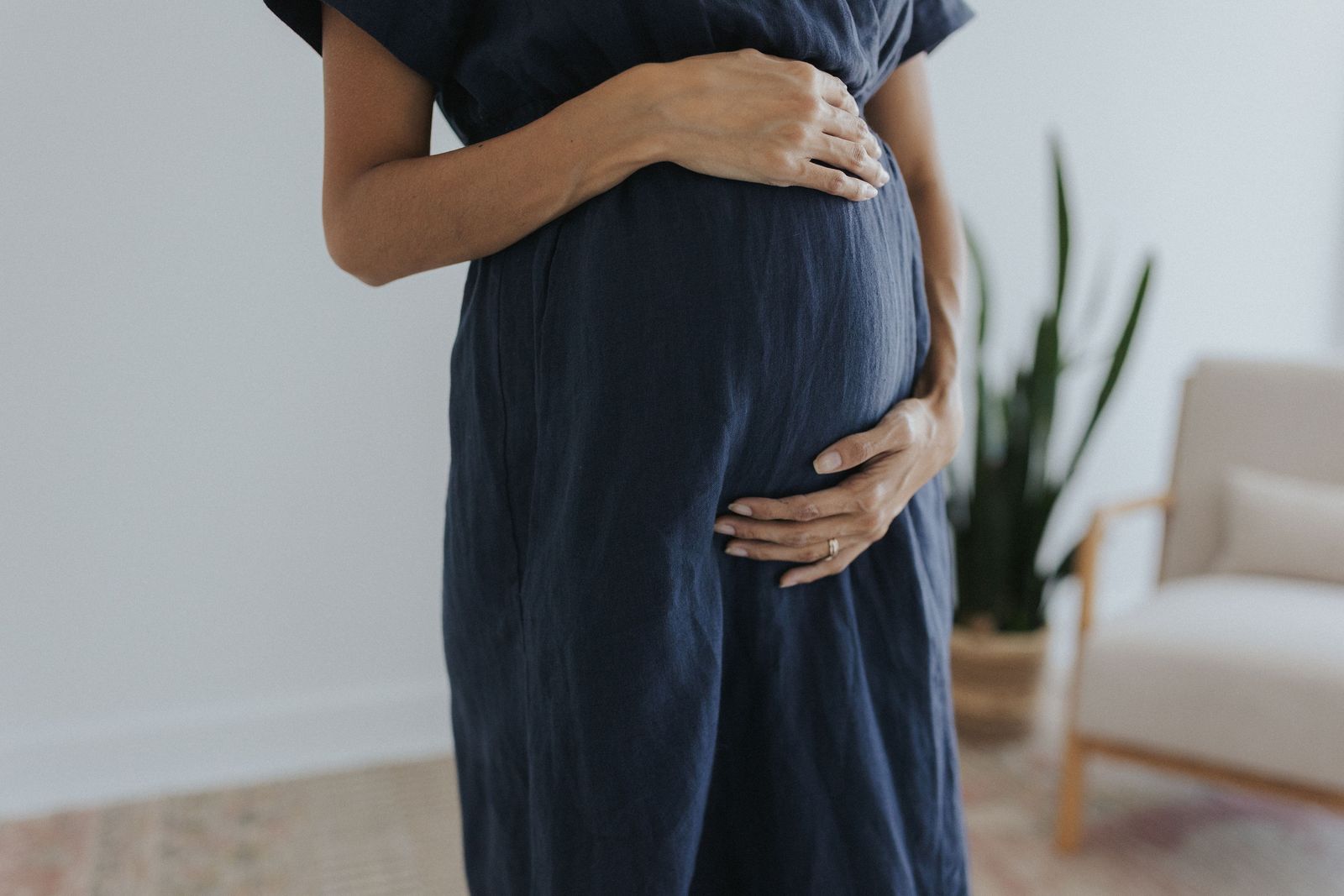 a pregnant woman standing in a living room