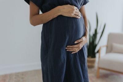 a pregnant woman standing in a living room