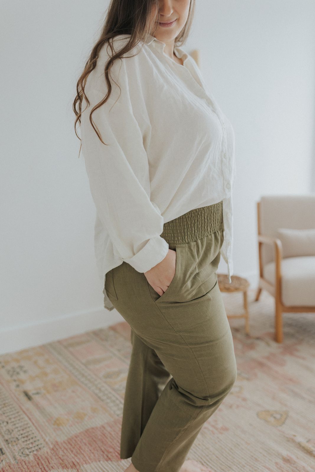 a woman in a white shirt and khaki pants