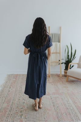 a woman standing on a rug in a room