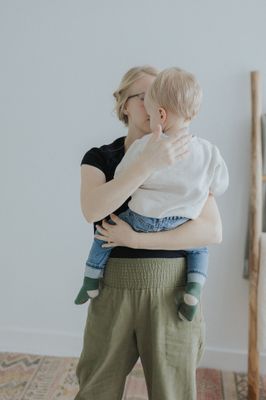 a woman holding a baby in her arms