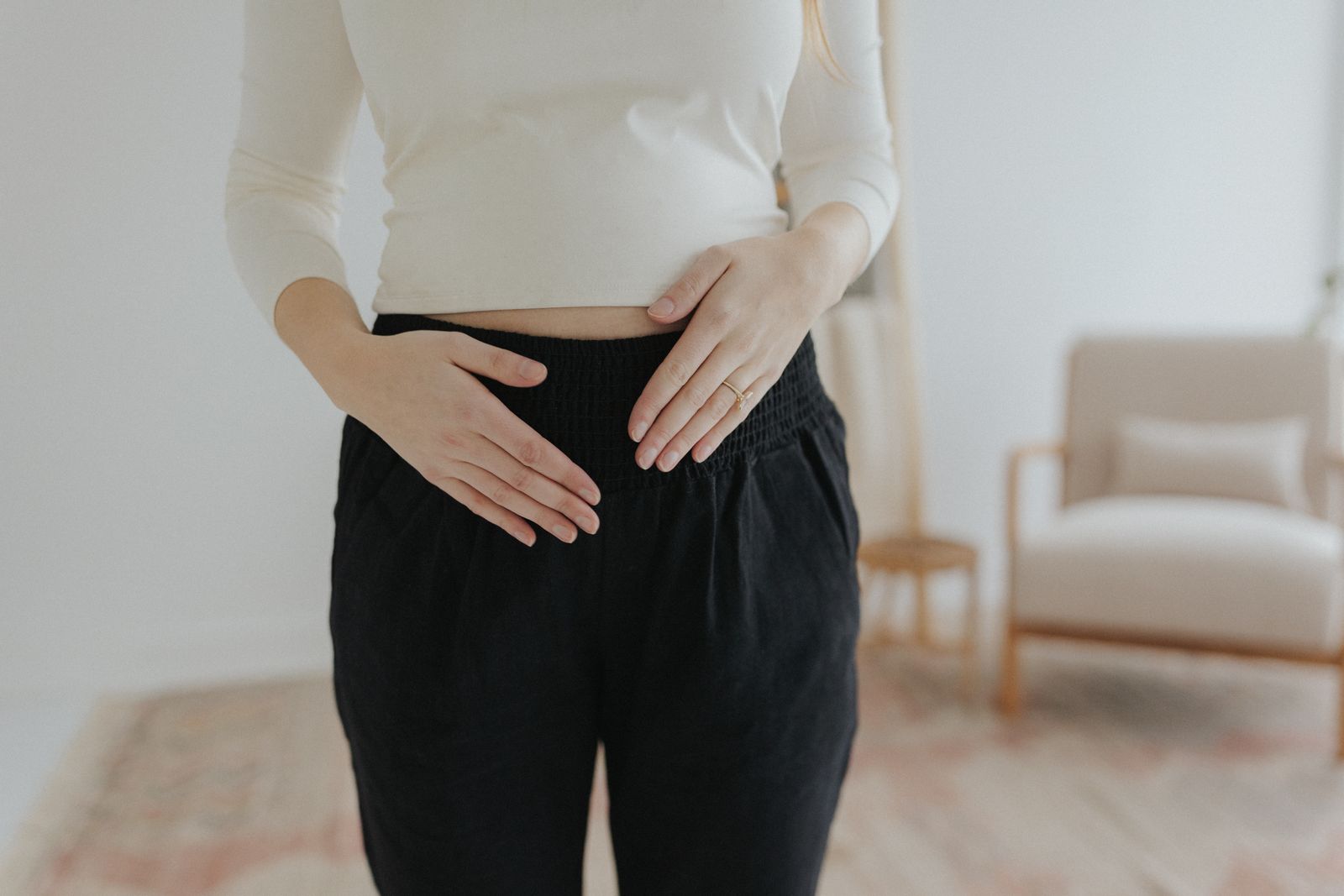 a woman standing in a room with her hands on her hips