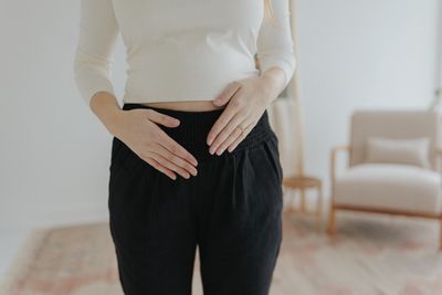 a woman standing in a room with her hands on her hips