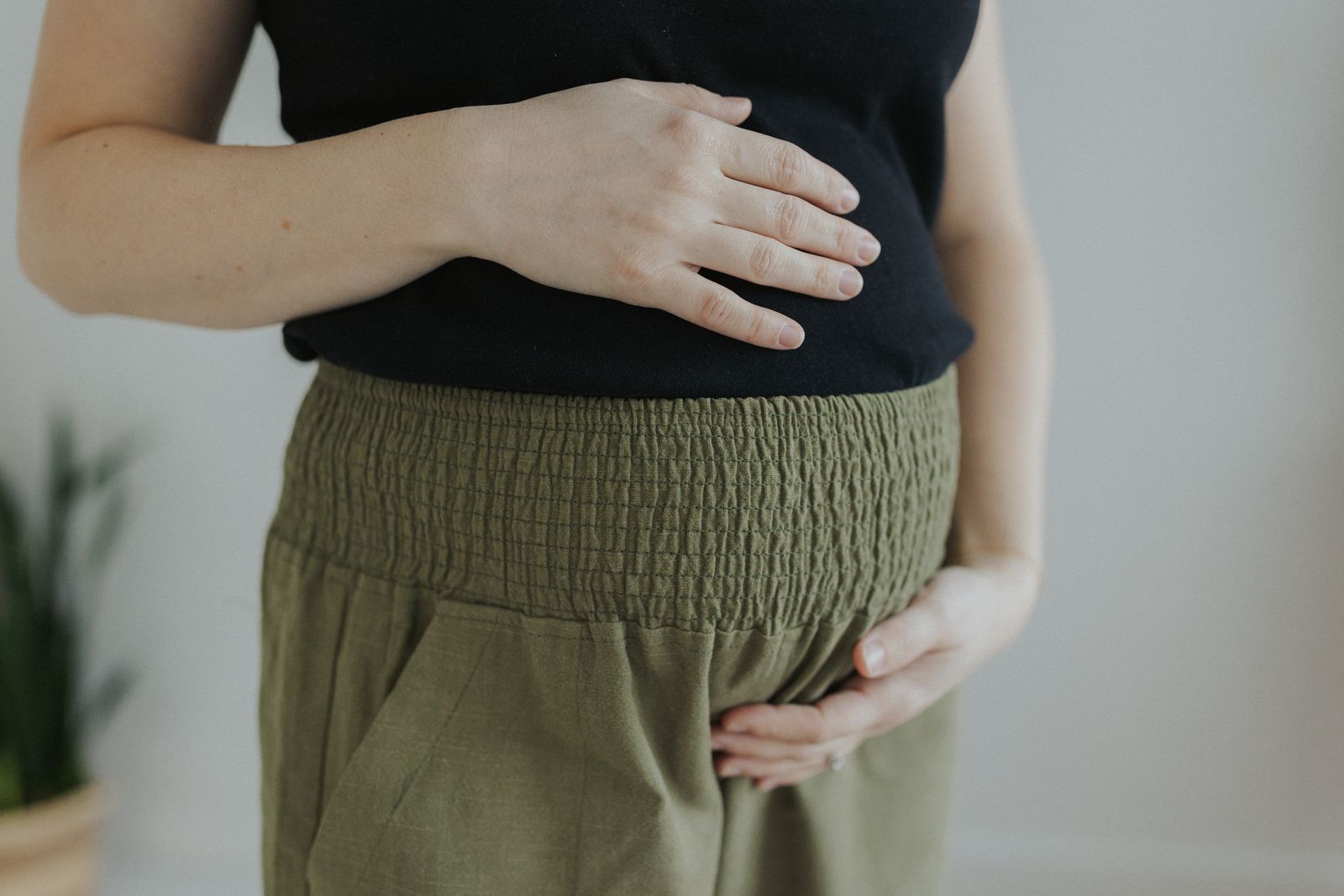 a woman with her hands on her stomach