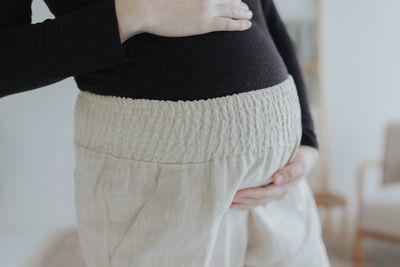 a woman is holding her stomach with her hands