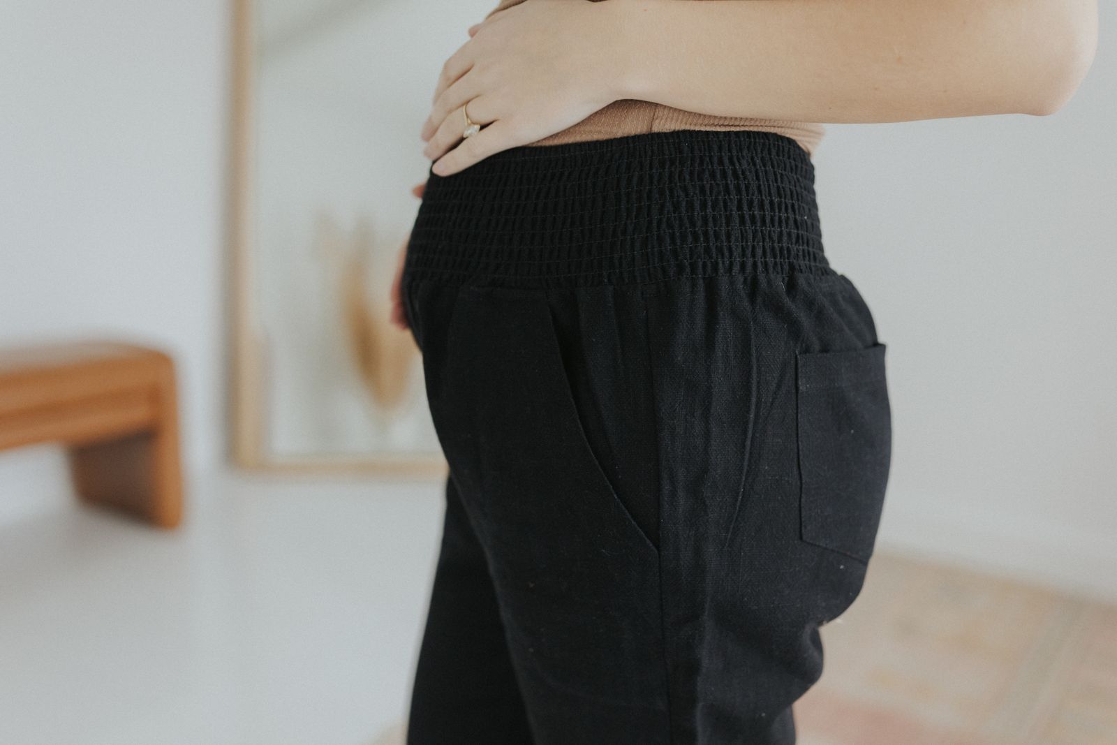 a woman standing in a room with her back to the camera