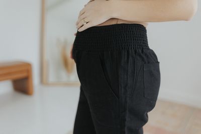 a woman standing in a room with her back to the camera