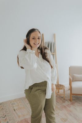 a woman in a white shirt and khaki pants