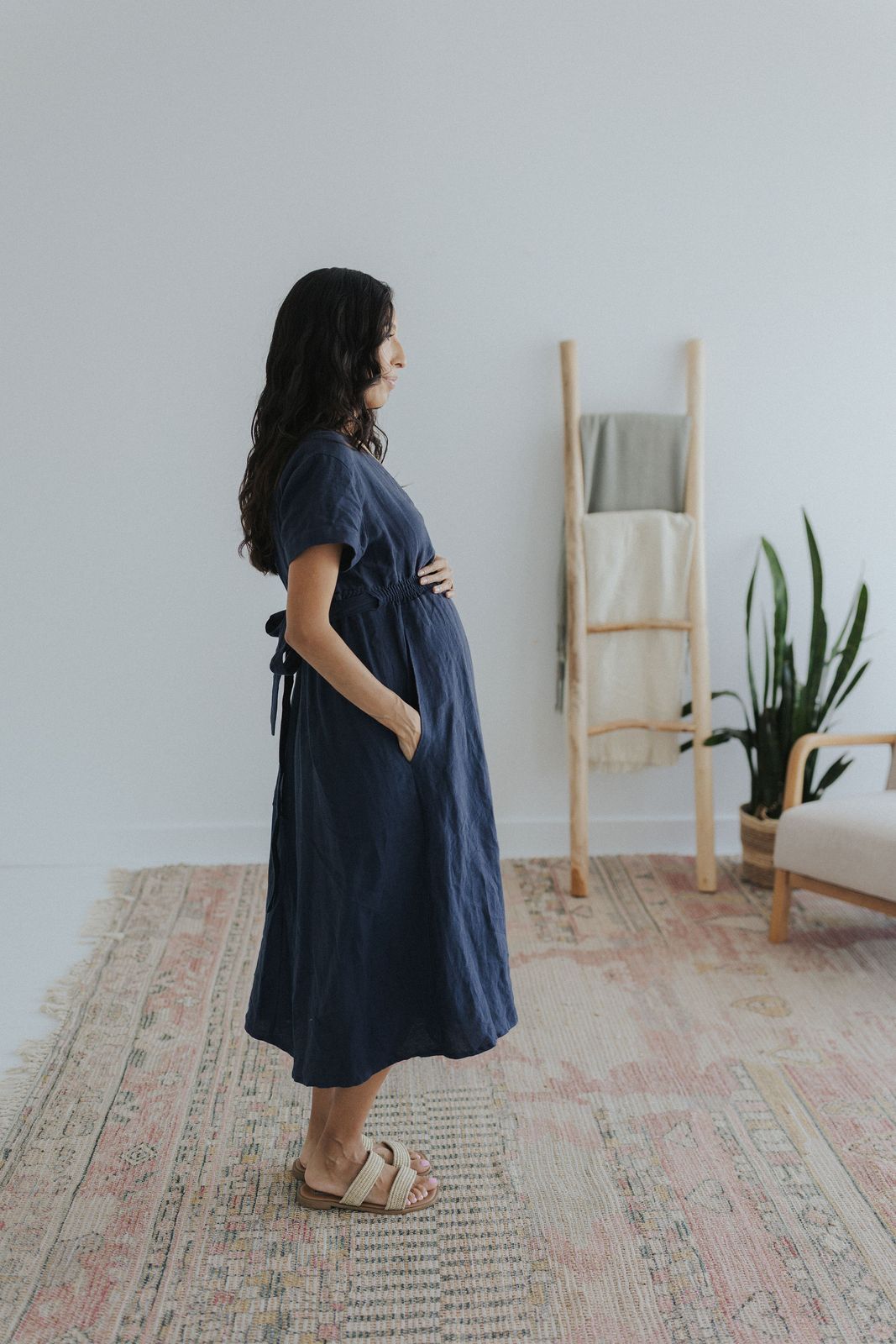 a woman in a blue dress standing in a room