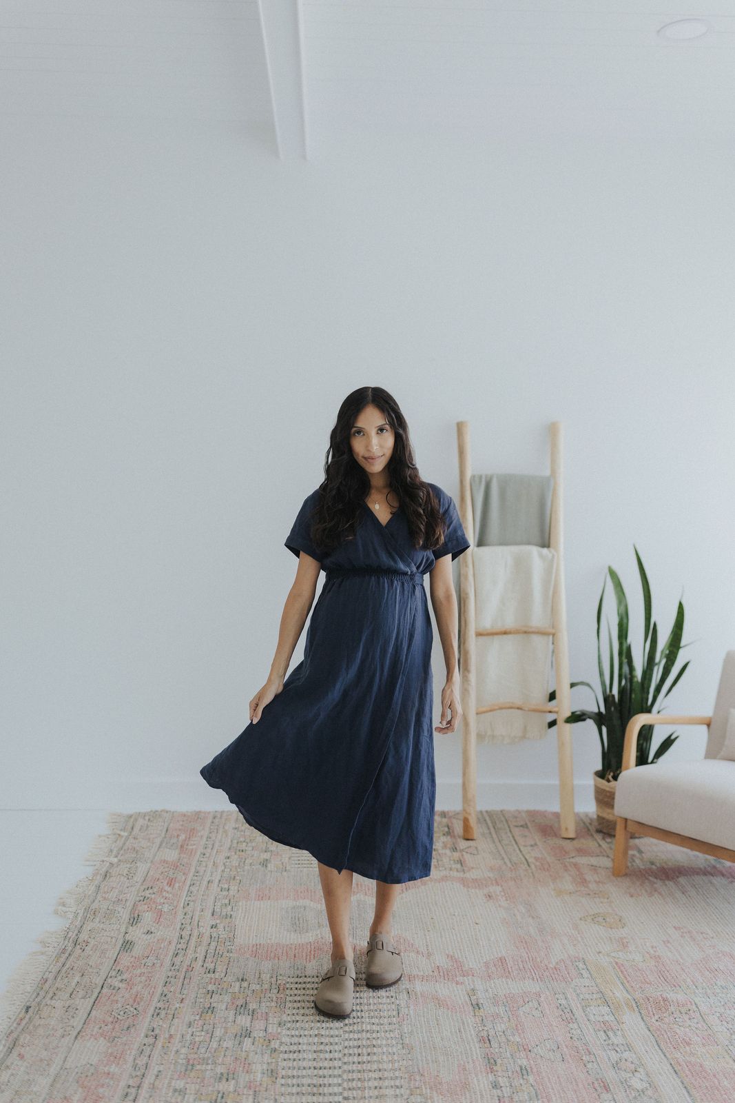 a woman standing on a rug in a room